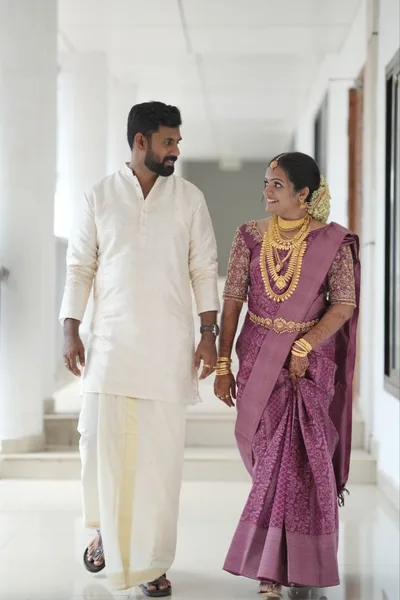 Bride in mauve silk walking beside the groom