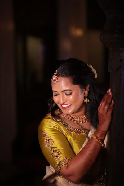 Kerala bride in a gold embroidered blouse, close portrait