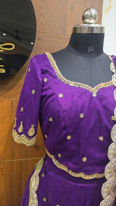 Purple blouse with gold work at the neckline
