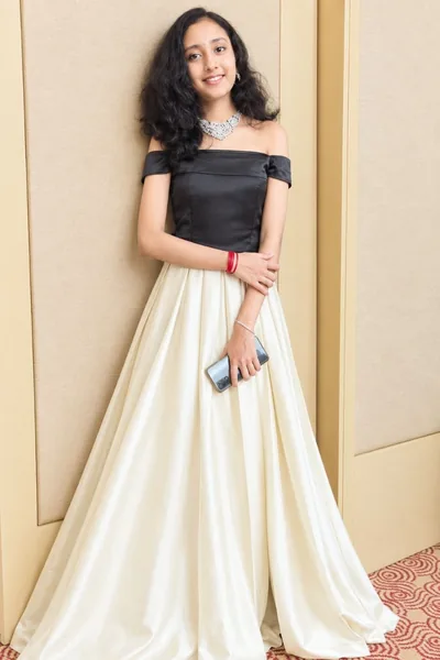 Ivory gown with an off-shoulder black satin bodice