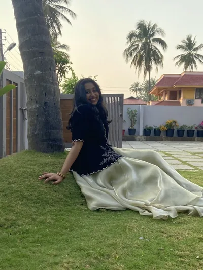 Black velvet peplum with an ivory skirt spread on a lawn