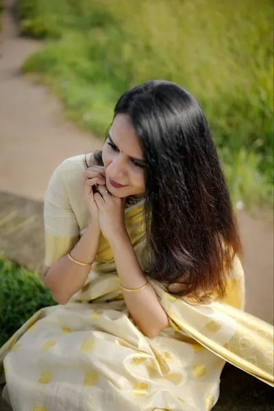 Ivory-and-gold set saree, close portrait