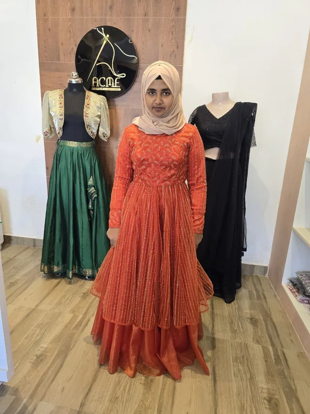Client in an orange anarkali at the ACME studio